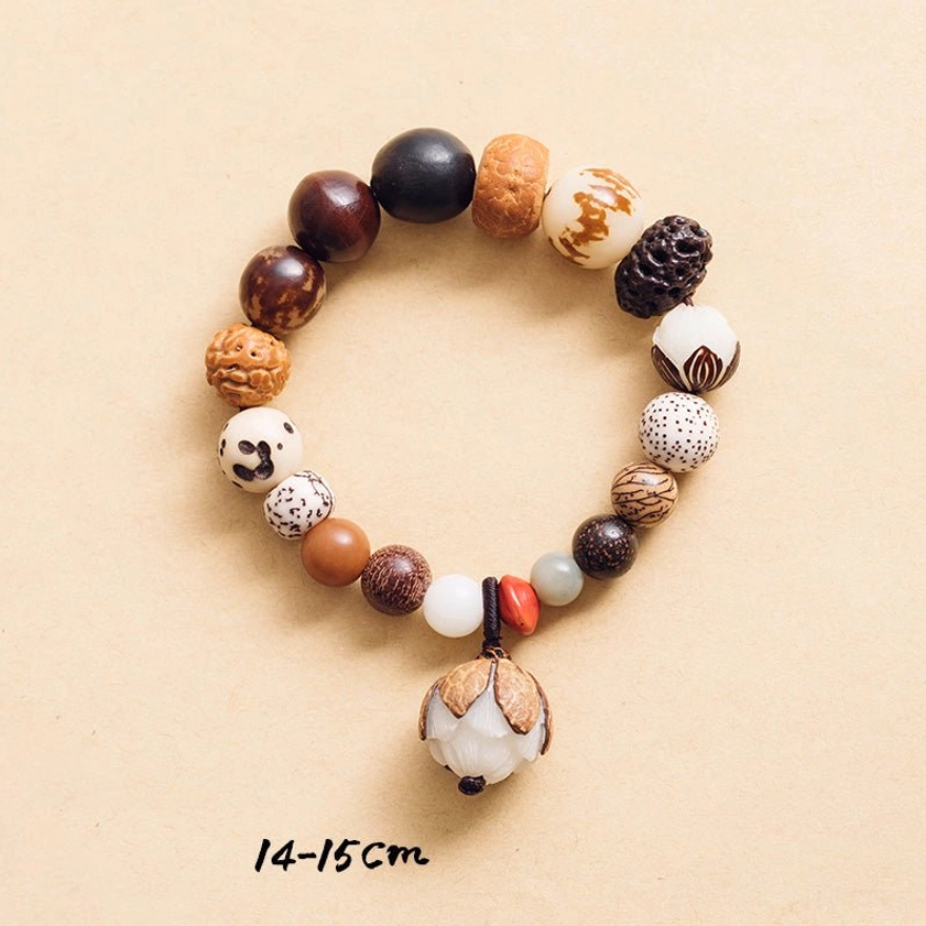 Bodhi seed bracelet 14-15cm size flat lay with lotus charm on light background
