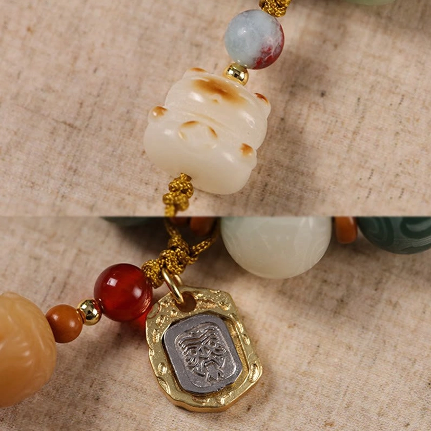Buddhist prayer bracelet made with natural Bodhi seeds and sacred charm pendant on neutral background
