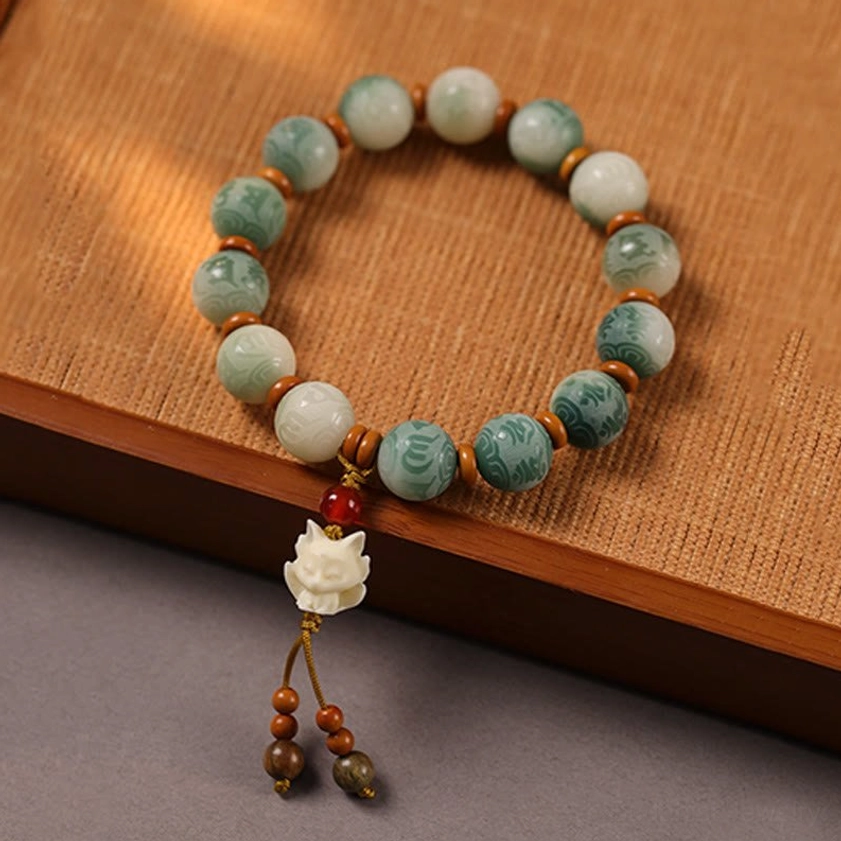 Buddhist Bodhi bead bracelet with cat protective charm pendant featuring carved details and tassel