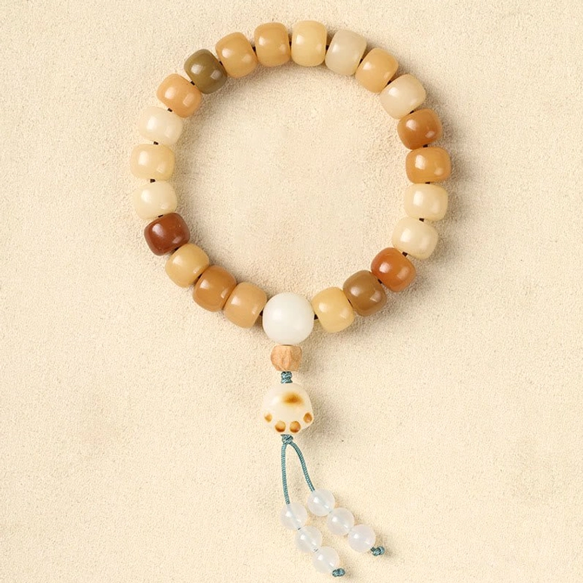 Bodhi seed bracelet with cat claw tassel charm accent, earthy wooden beads and decorative tassel detail, unique bohemian Buddhist prayer bracelet