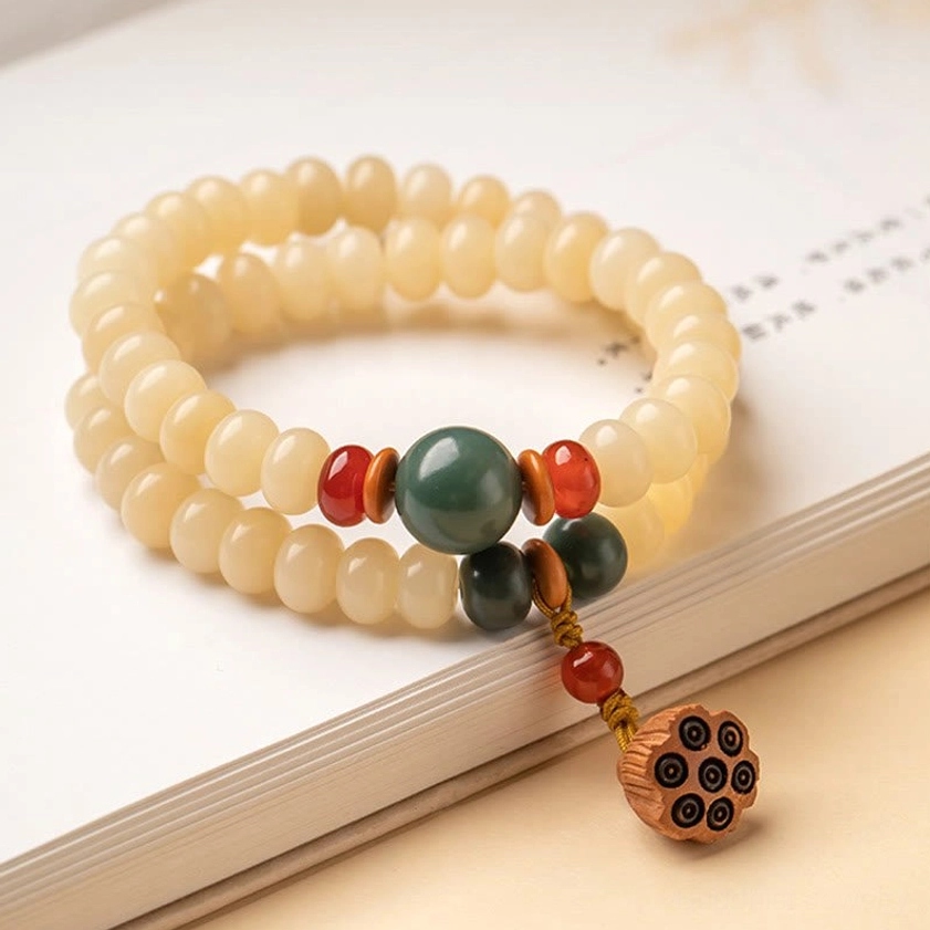 Neatly arranged double-strand Bodhi seed bracelet beads on book surface with full product view
