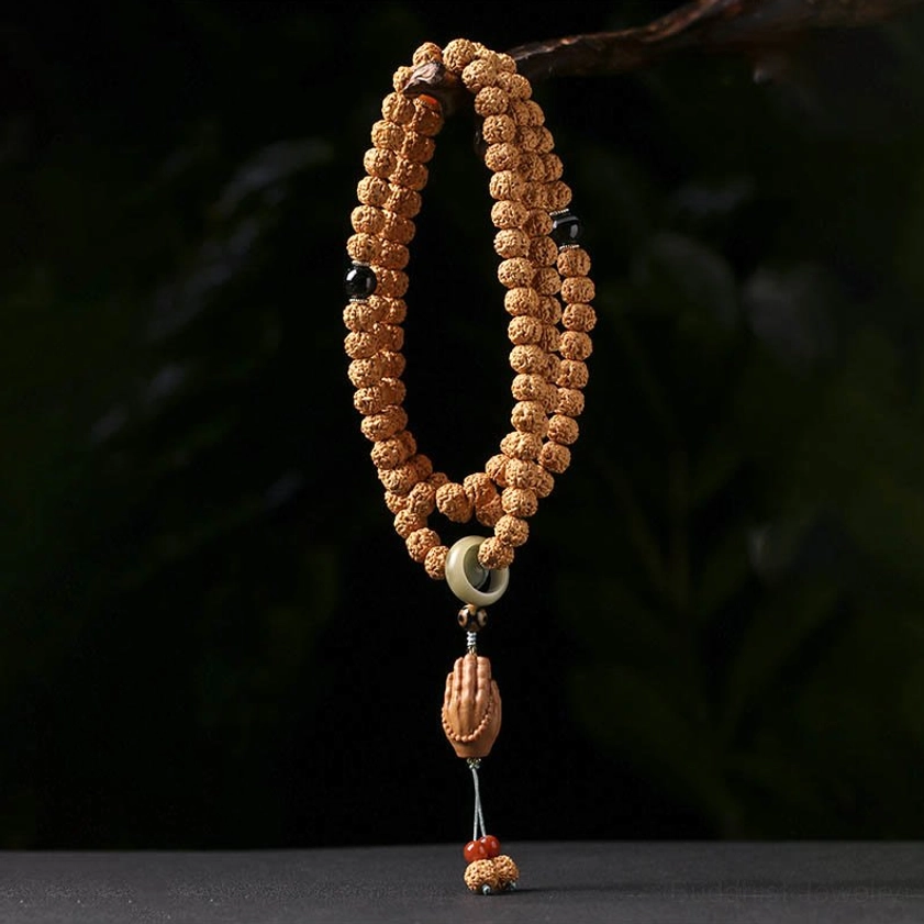 Authentic Buddhist prayer bracelet featuring natural bodhi seeds, protective Dzi bead, and spiritual Buddha hand pendant in vertical display