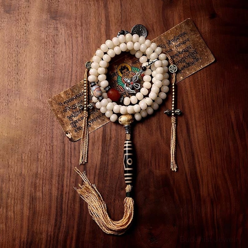 Close-up of Buddhist mala beads showing bodhi seed texture and gray agate gemstone details, prayer necklace craftsmanship