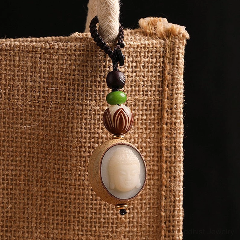 Bodhi seed Buddha keychain hanging on burlap bag with compact pendant and layered beaded accents