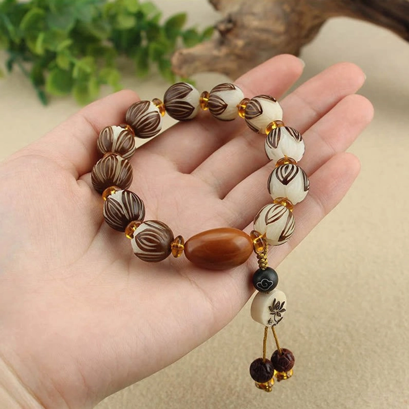 Bodhi seed lotus meditation bracelet close-up detail showing carved lotus charm and natural bead texture