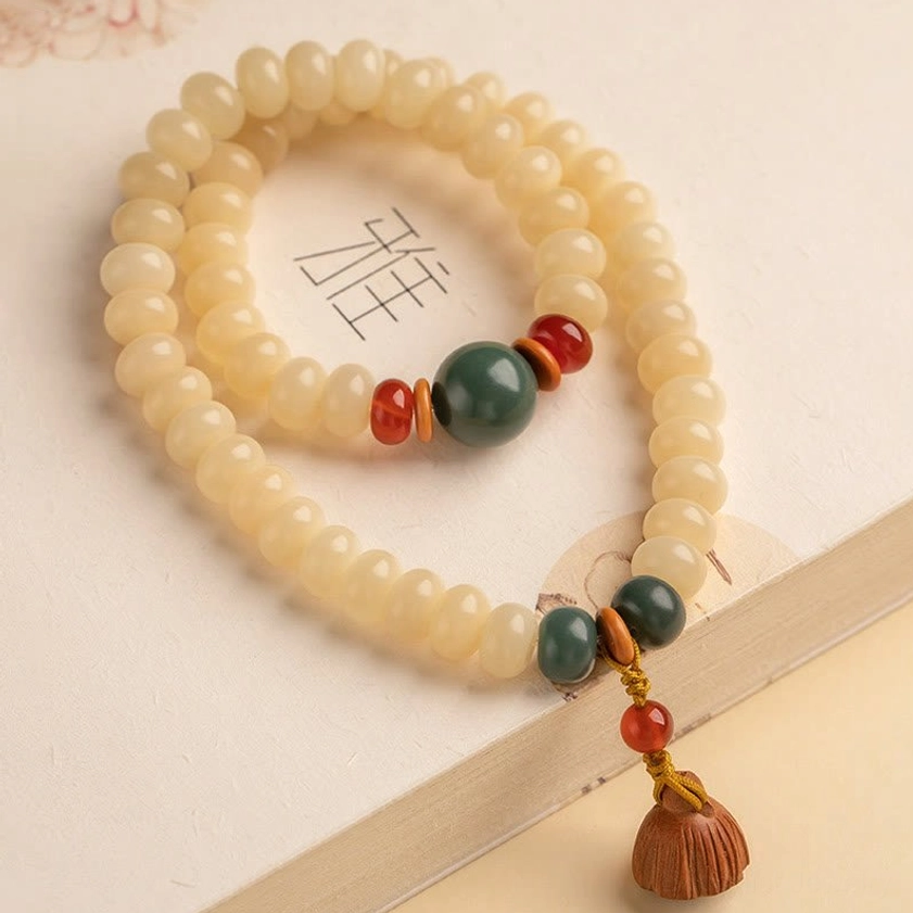 Bodhi seed double wrap bracelet and lotus pendant arranged in spiritual mindfulness setting