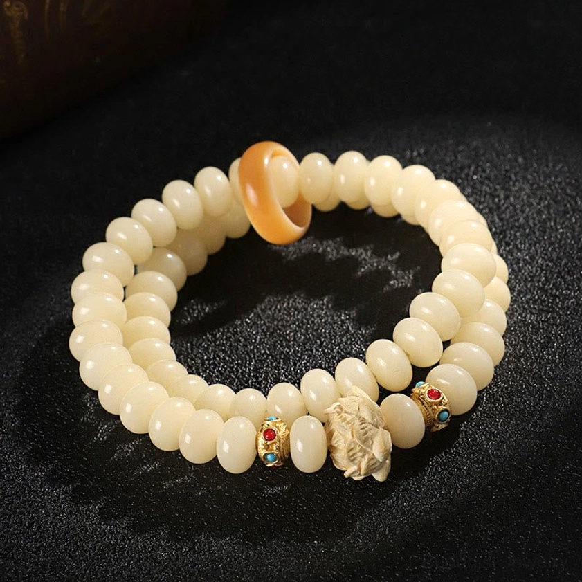 Bodhi seed peach wood double wrap bracelet side view - showing wooden lotus centerpiece and enamel decorative beads