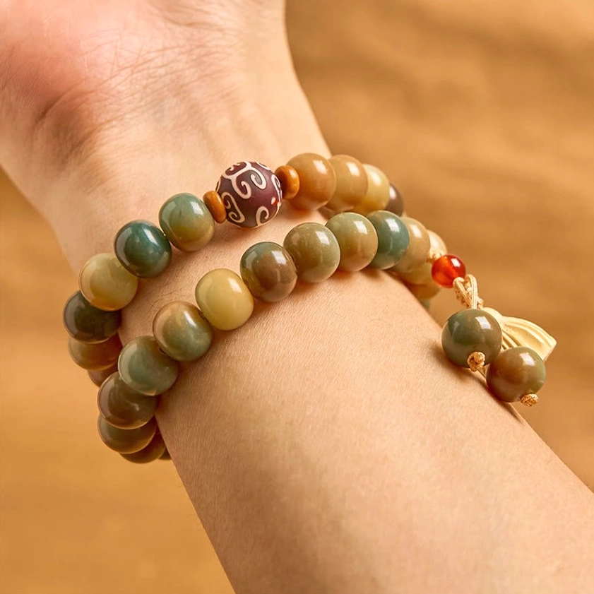 Spiritual Buddhist bracelet worn on wrist showing double wrap styling and complete charm design in lifestyle setting