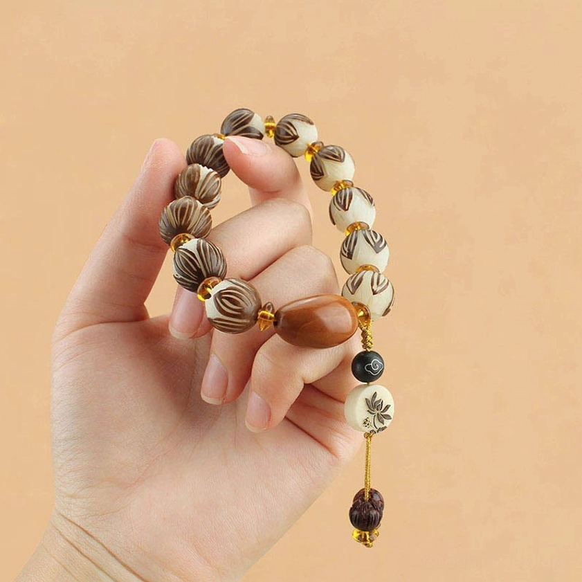Hand-worn bodhi seed lotus bracelet showing comfortable fit and matching lotus bead design on wrist