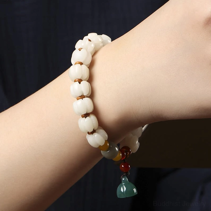 Spiritual bodhi seed bracelet on wrist displaying lotus charm pendant clearly