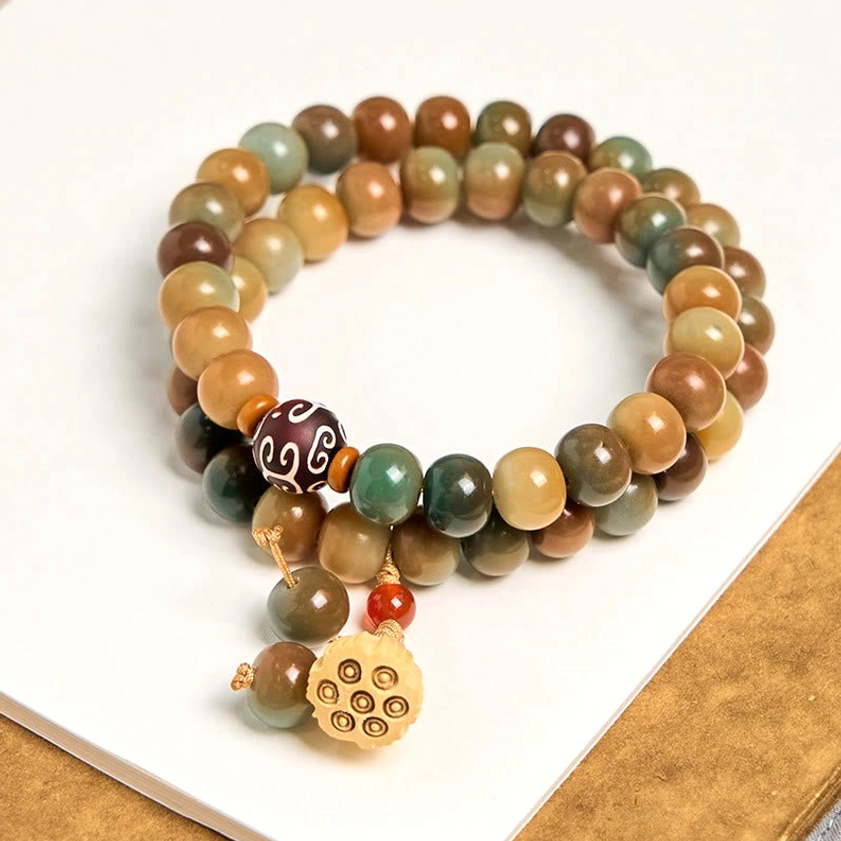 Handmade Buddhist double wrap bracelet coiled styling showing mixed color beads and lotus pod charm details