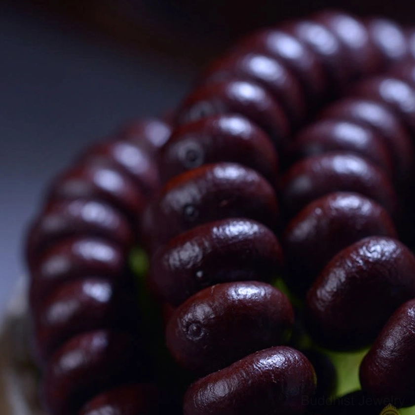 Detailed macro view of purple bodhi seed beads showing smooth matte finish and natural coloring