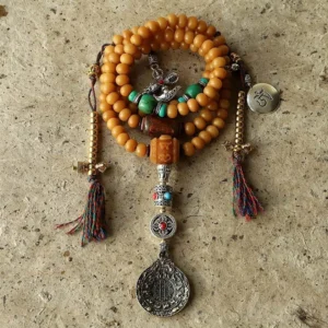 108 Bodhi Seed Mala Bracelet with Copper Bagua Amulet and Vajra Charms on Stone Surface