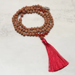 108 bodhi seed prayer mala with om charm flat lay top view showing complete necklace with red tassel