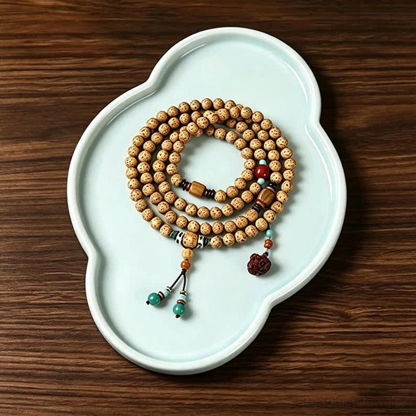 Handcrafted Star Moon Bodhi Seed Buddhist prayer mala beads with turquoise accessories on blue ceramic tray flat lay