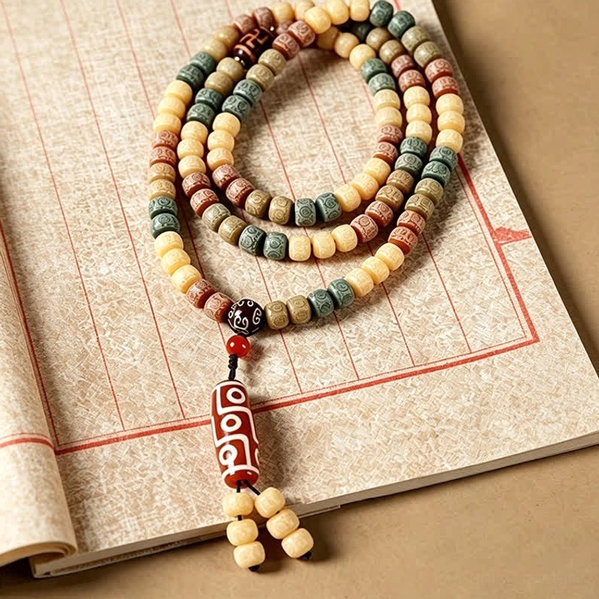 Bodhi seed mala beads bracelet with traditional buddhist pendant - flat lay