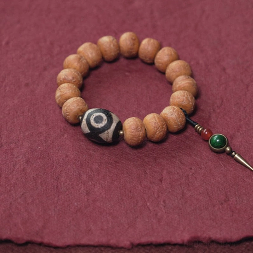 Handcrafted bodhi seed mala bracelet with sacred dzi bead and tassel charm