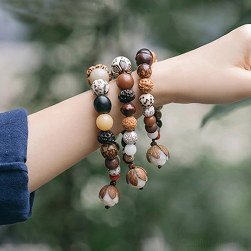 Bodhi seed mala bracelet worn on wrist with foliage background showing natural bead texture