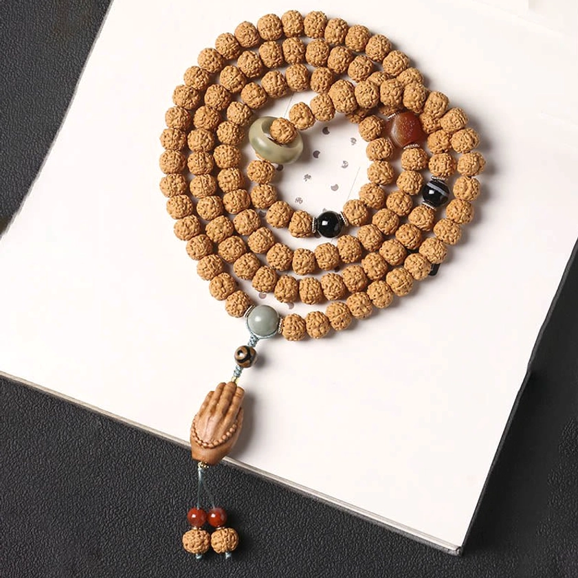 Handmade bodhi seed mala bracelet spread on white background showing natural bead texture and mixed accent stones
