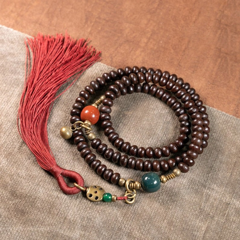 Authentic 108 Mala Prayer Beads Set with reddish-brown purple bodhi seeds, vintage brass accessories, and red tassel detail