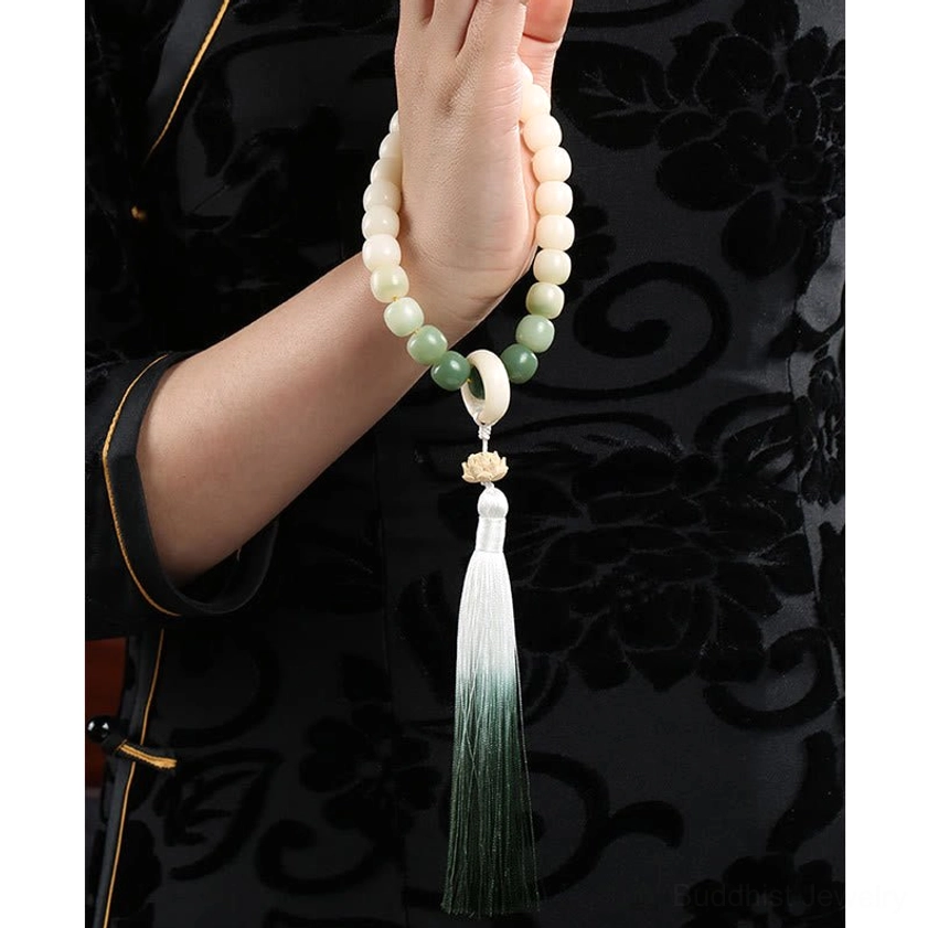 Close-up of bodhi seed mala bracelet showing individual ombre beads, textured surface, and spiritual charm detail - authentic handmade Buddhist prayer jewelry