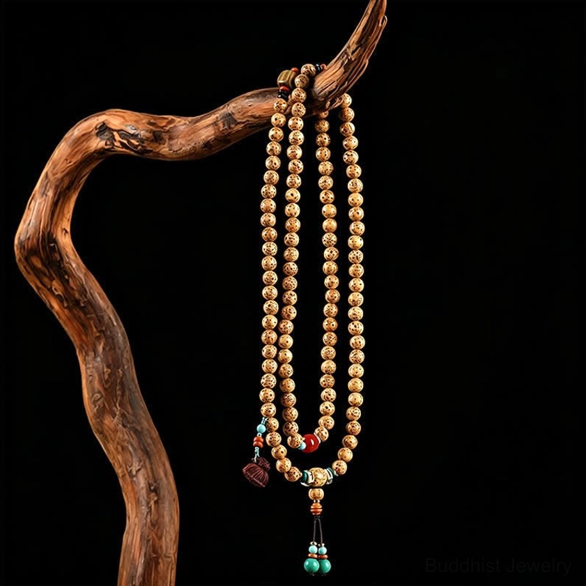 Long Star Moon Bodhi Seed Buddhist prayer mala necklace hanging on wooden display stand with turquoise tassel
