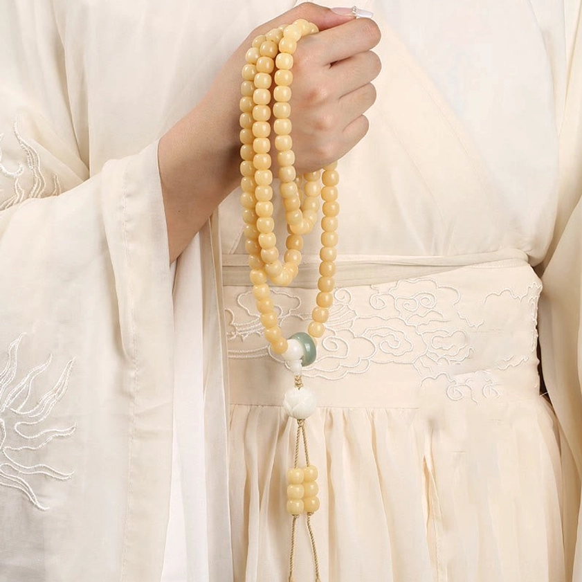 Long Bodhi Seed Mala Necklace side view worn on traditional clothing with decorative pendants