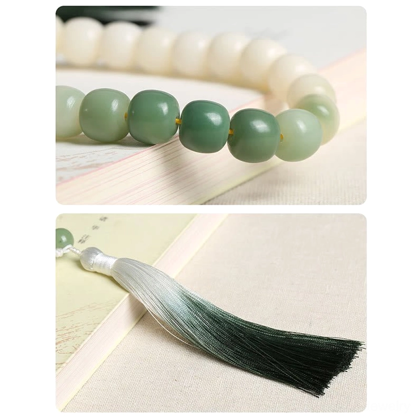 Close-up of ombre silk tassel accessory from bodhi seed wrist mala showing dark to light green gradient color - artisan crafted Buddhist meditation bracelet detail