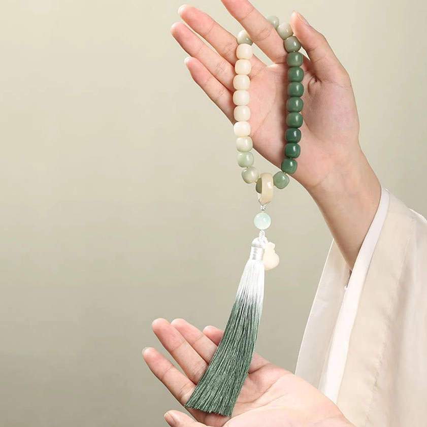 Handmade bodhi seed wrist mala featuring premium elastic cord, ombre gradient beads, and decorative tassel - authentic Buddhist prayer bracelet for meditation