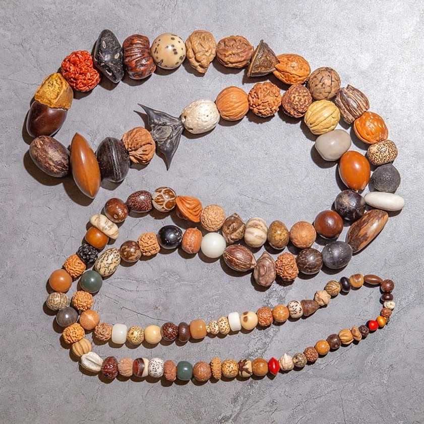 Two-layered bodhi seed mala set featuring large prayer bead strand and small wrist bracelet with red spacing beads