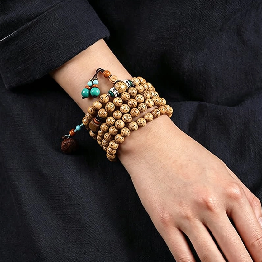 Wrapped Star Moon Bodhi Seed mala bracelets worn on wrist with wooden lotus charm and turquoise details close-up