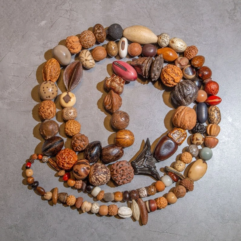Handcrafted bodhi seed meditation mala with red accent bead and dark wood spacers for Buddhist spiritual practice