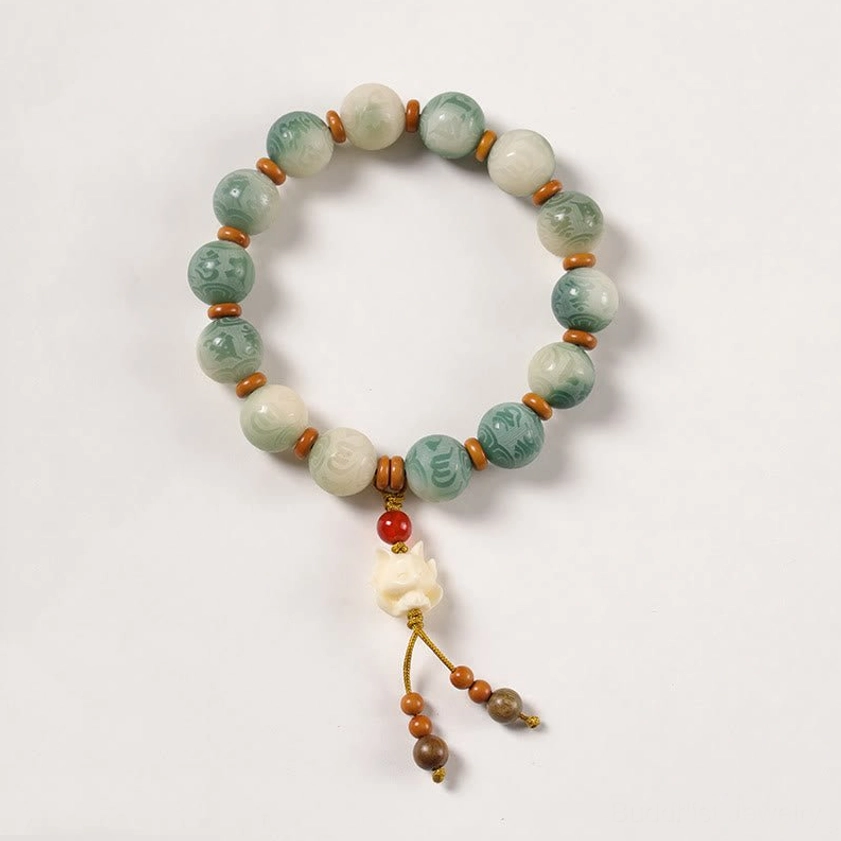Bodhi seed bracelet with nine-tailed fox protective charm pendant and sacred beads on white background