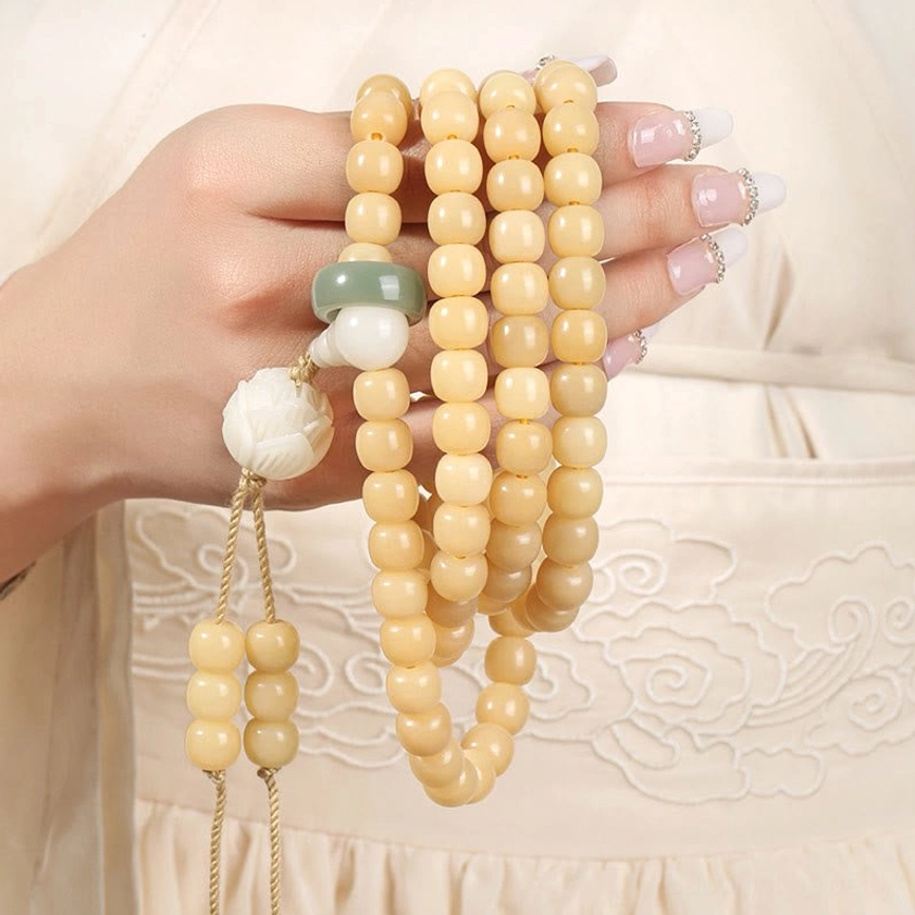 Bodhi Seed Prayer Beads close-up hand holding with jade jump ring and lotus tassel accessories