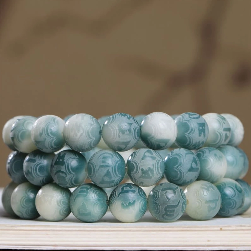 Bodhi seed prayer bracelet showcasing gradient green-white finish and sacred mantra engravings