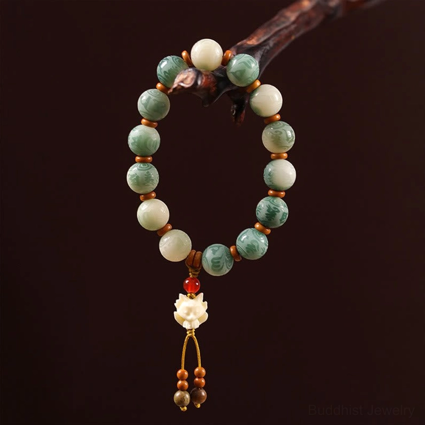 Spiritual Bodhi seed bracelet with protective charm showing natural bead variations and elastic string