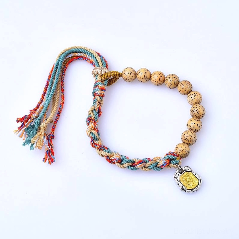 Adjustable Buddhist red and blue string bracelet with spotted bodhi seed beads and metal wealth goddess charm