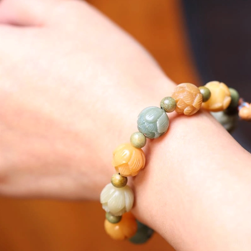Bodhi seed wrist bracelet close-up side view with mixed smooth beads and simple design on warm wooden background