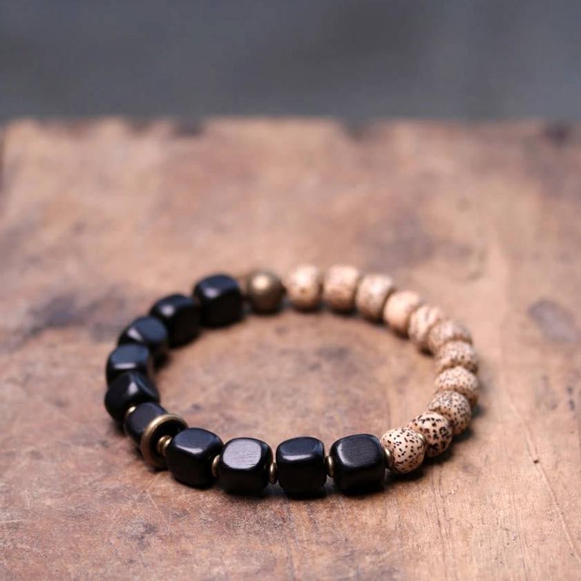 Buddhist bracelet with square black ebony wood bodhi seeds and brass spacers overhead flat lay
