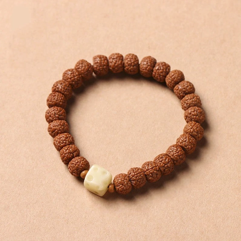 Coiled bodhi seed wealth bracelet with protective three-eye Dzi bead and spiritual Buddha hand accessory