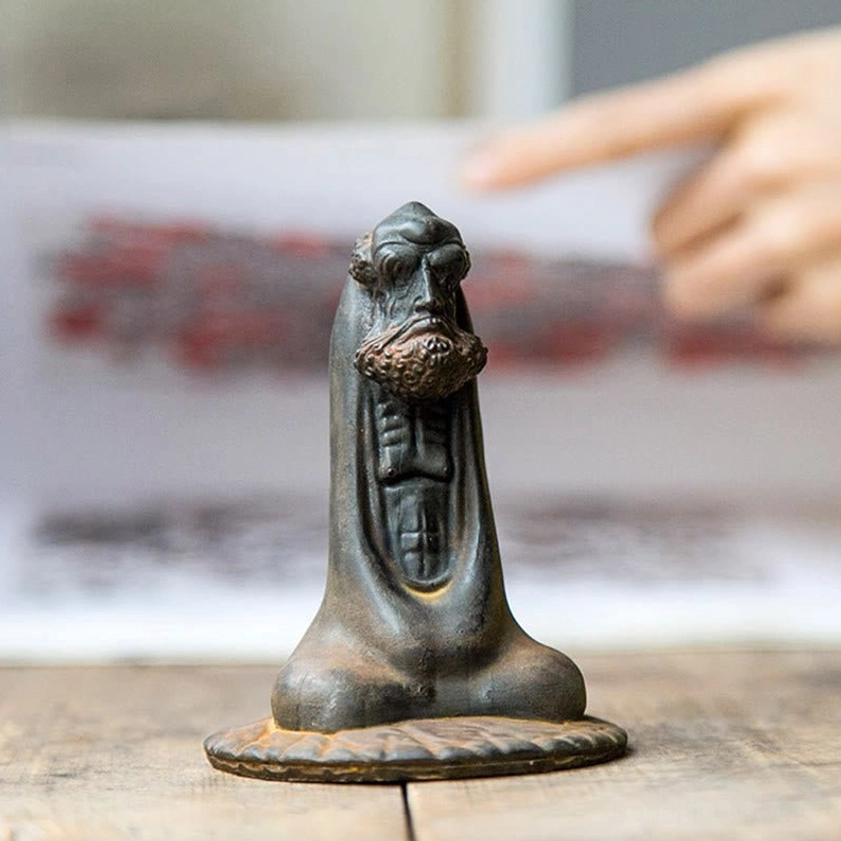 Bodhidharma decorative statue desktop display with paper background showing craftsmanship