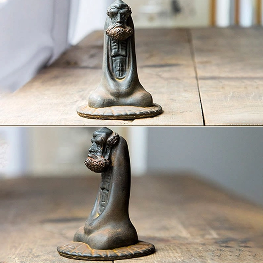 Bodhidharma resin sculpture angle view showing hand-sculpted details and natural patina