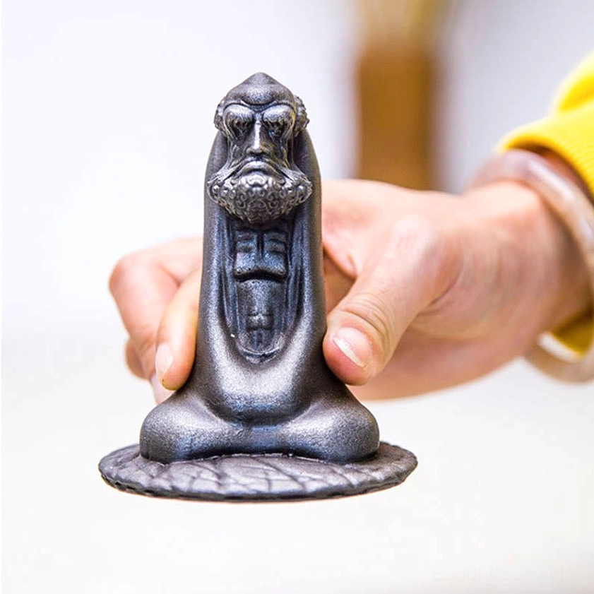 Bodhidharma meditation statue display setup showing placement in spiritual space with ambiance