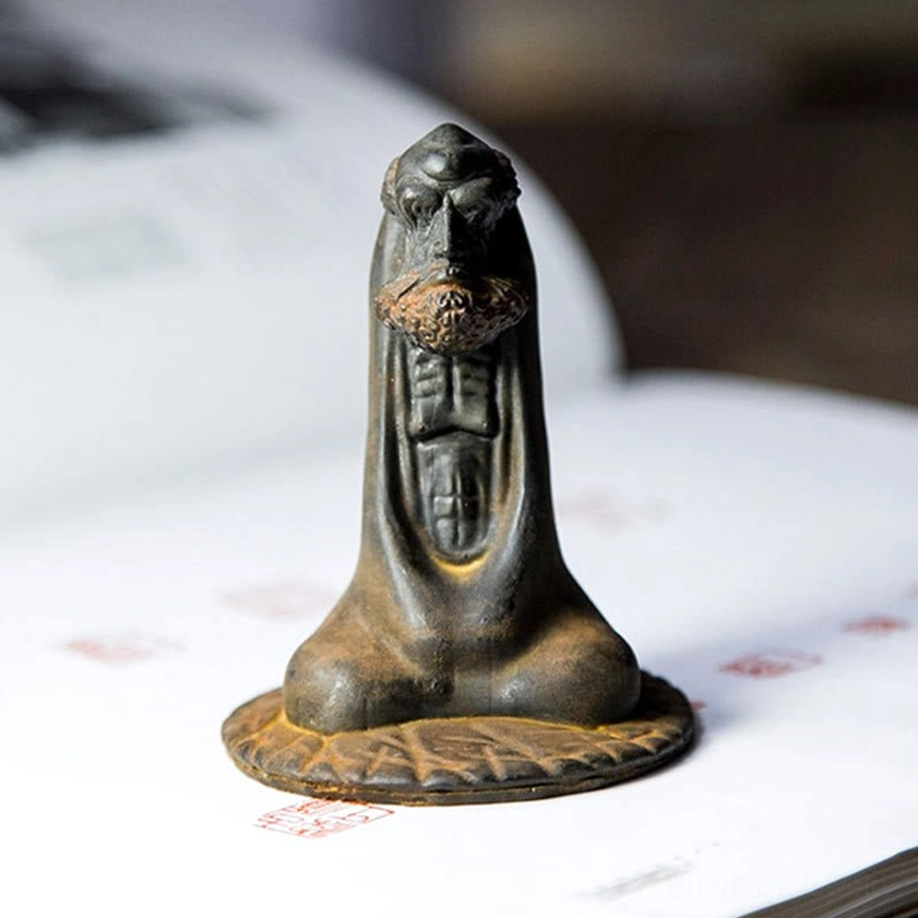 Bodhidharma home decoration three-quarter view on table showing engraved chest and lotus base