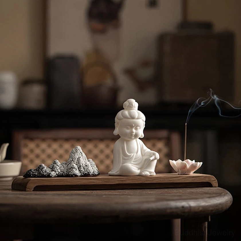 Bodhisattva ceramic incense burner with mountain stone decorations in warm home tea room lighting