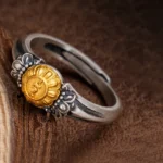 Bodhisattva Tara sterling silver protection ring with gold-plated emblem, side close-up view showing vintage texture and craftsmanship