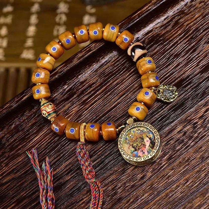 Bone bead Buddhist bracelet with lazurite and copper - B style variant featuring traditional design