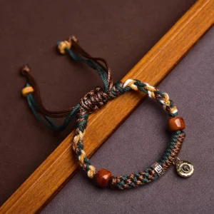 Handcrafted bone bead Buddhist string bracelet with multicolor braided rope, metal pendant, and adjustable drawstring closure - top view
