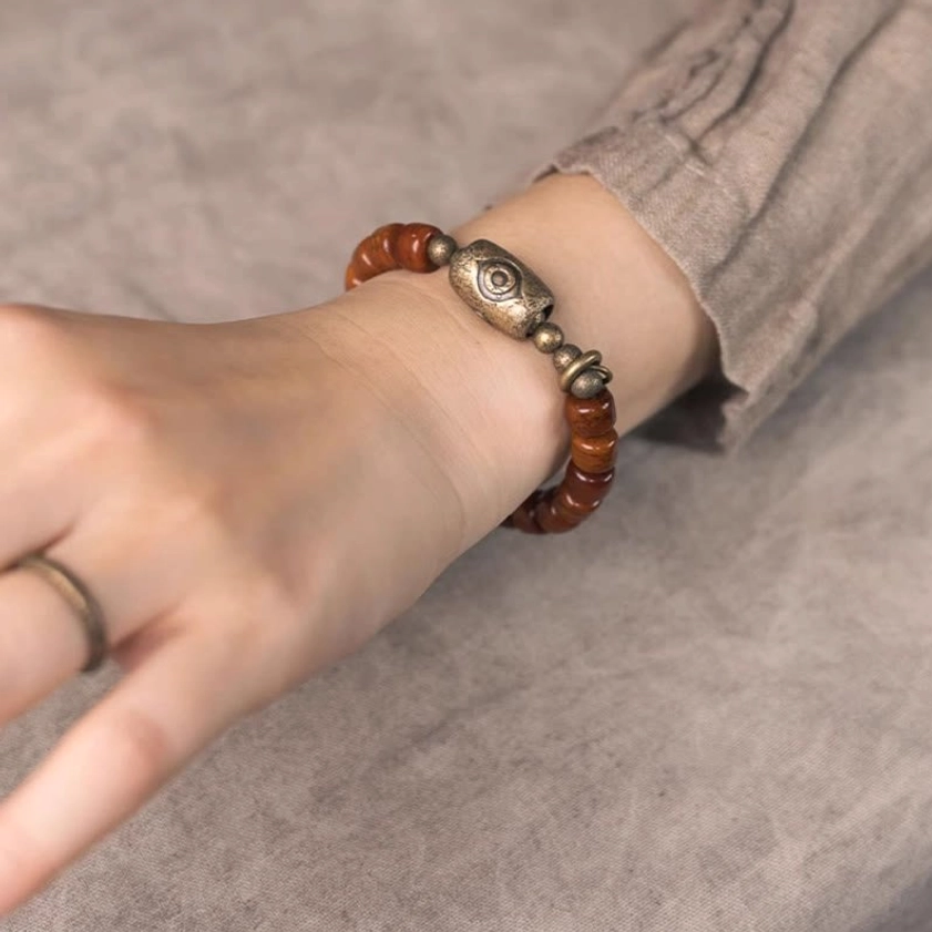 Bone beads Dzi eye copper cone Buddhist bracelet for strength protection and spiritual grounding lifestyle wear