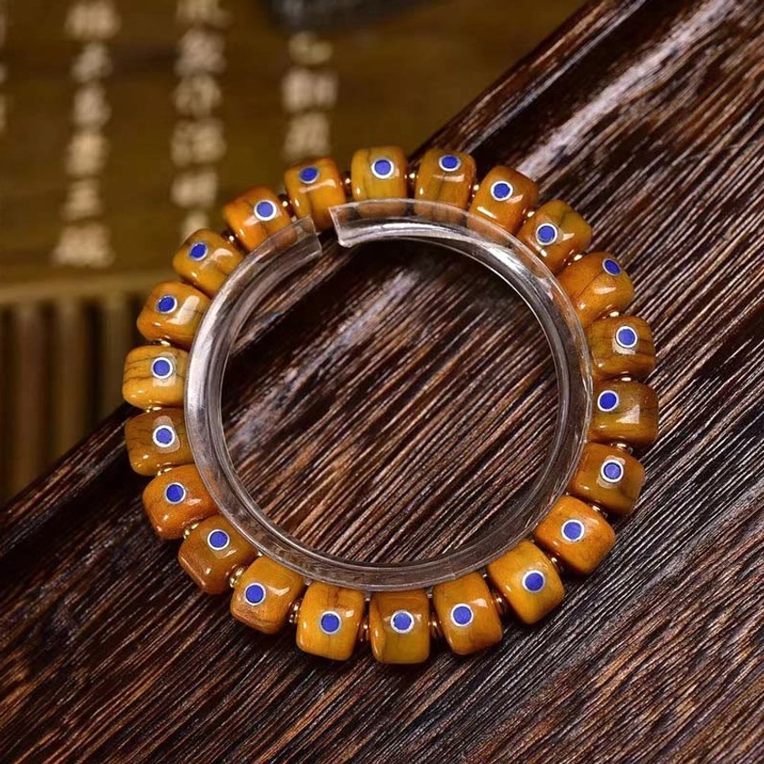 Loose bone beads with blue dot inlays display showing bead size and craftsmanship detail
